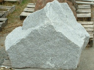Photo of White Broken Granite Boulder. Use in landscaping. Natural stone sold by Rolleri Landscape Products.