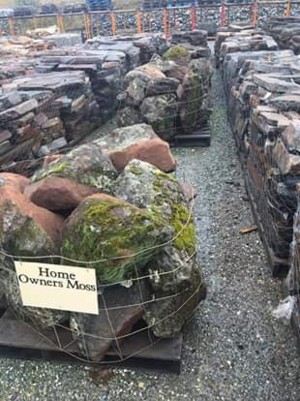 Photo of Homeowner Moss Rock. A Califoria moss rock with lichen and moss. Use for Boulders, Drystack stone wall, Water feature. Natural stone sold by Rolleri Landscape Products.