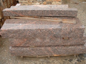 Photo of Mahogany Granite Ledgestone. A natural stone product of Rolleri Landscape Products.
