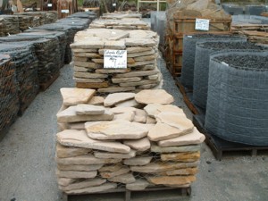 Photo of Colorado Buff Sandstone Patio Tumbled. Random shaped sandstone flagstone used for walkways, patios, wall cap, pool coping, or veneered on walls. Dry laid or masonry use. Natural stone sold by Rolleri Landscape Products.