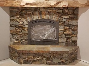 Photo of fireplac surrond 49er Brown Ledge mixed with sawed natural stone veneer. 